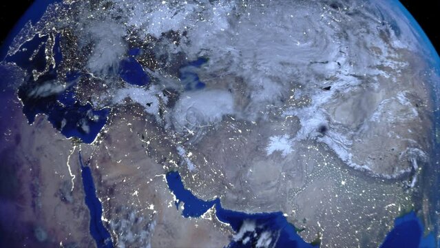 Zoom out of Iran through clouds to see the Earth from space.