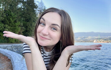 Travel advertising for travel agencies Beautiful young woman 25 years old laughs, shows her hands...