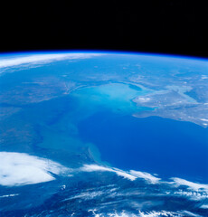 Photo of earth taken from outer space. Blue and turquoise hues with white clouds. Russia can be seen along with the Volga River. Elements of this image furnished by NASA. 