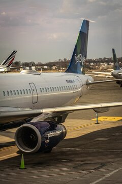 Vertical shot of a jetBlue plane landing at a gate