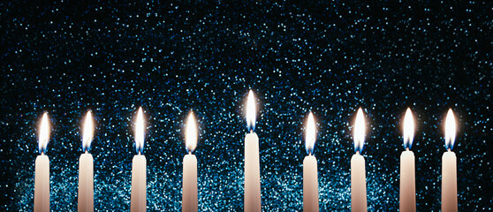 Hanukkah candles. Traditional candelabrum with burning candles on black background. Celebrating...