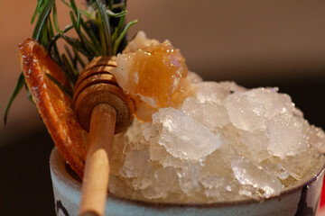 cocktail with honey, dried orange and crushed ice
