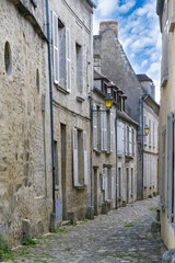 Senlis, medieval city in France, typical cobblestone street with ancient houses
