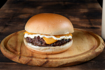sandwich with beef burger salad onion cheese and bacon fast food