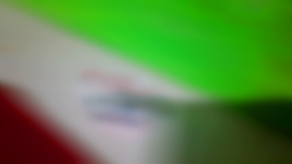Abstract blurred background with the main composition of green, white, and a little red.