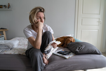 Depressed middle-aged woman looks away to get distracted from financial crisis and life problems....