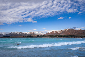 The Church Of Good Shepherd in late winter with beautiful snow capped Southern Alps mountain range in the background. Lake Tekapo, Canterbury, New Zealand South Island.