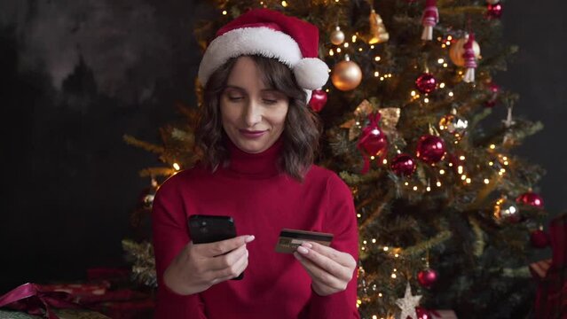 woman make purchase online using smartphone and credit card buy New Year gifts