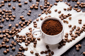 Roasted coffee beans and ground coffee, on dark background, closeup image, space for text