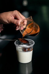 Dirty Coffee - A glass of espresso shot mixed with cold fresh milk in coffee shop cafe and restaurant