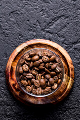 Roasted coffee beans, on dark background, closeup image, space for text