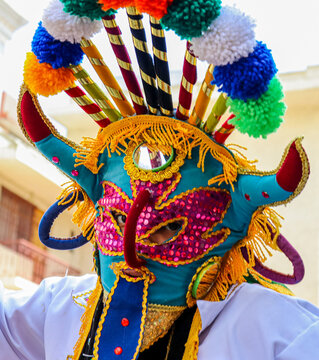 The annual Christmas parade Pase del Nino (Traveling Child) at historic center of city Cuenca. Participant dressed in mask of folk character called Diablo Huma (Devil). Ecuador