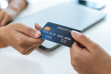 Young businesswoman paying order having contactless payment with cardit card