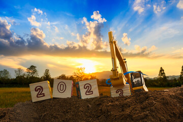 Concept Happy new year 2023,crawler excavator of lift up bucket that is installing the number three...
