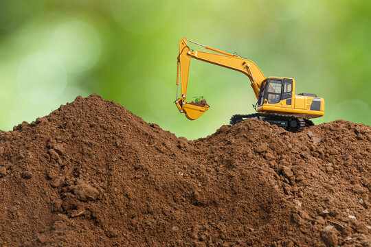 Crawler excavator with bucket lift up are digging  plant a tree  on the environment eco background ,reduce global warming