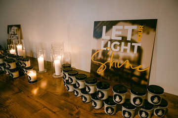 candles with let your light shine signage 