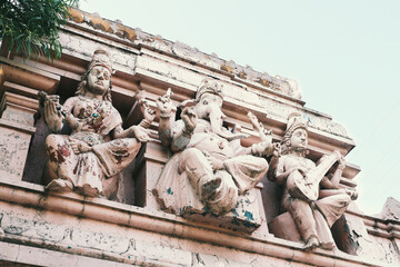 Lakshmi, Ganesha and Saraswati on the roof of a Hindu temple in Rishikesh, Uttarakhand, India.