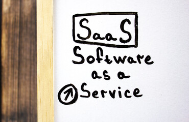 SaaS.Software as a Service - concept text on a white board written in black marker.
