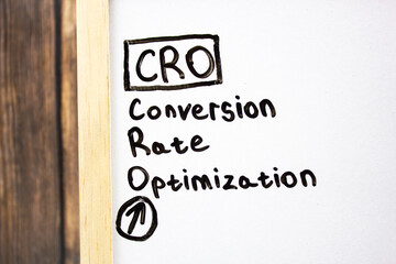 CRO. Conversion Rate Optimization- concept text on a white board written in black marker.