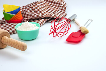 Set of kitchen utensils and ingredients for bakery on white background.