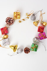 Red decorations for new year or christmas on white background (vertical photo). Festival, season and greeting card concept.