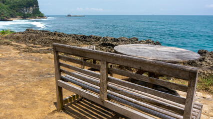 Fototapeta na wymiar wooden bench on the beach