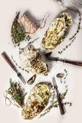 Fresh oyster and oregano. Food flat lay composition on a light background. Healthy and tasty natural seafood. Vertical shot
