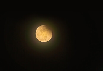 Real full blood moon, half moon in black sky with cloud