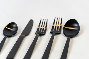 black metal forks and spoons on a white background, mexico