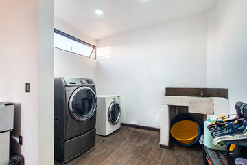 laundry room, with washing machine, dryer, detergent area, hand washing sink,