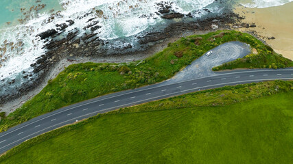 Aerial view  of the Coastal Road, sandy beach and  open sea in summer season Nature recovered Environment and Travel background