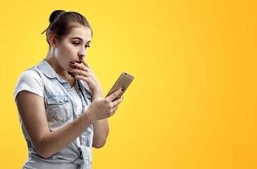 Naklejka premium Happy young woman with modern smartphone