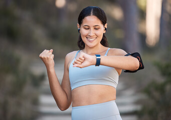 Fitness, exercise and woman celebrate goal with watch to check pulse, performance and time while in...
