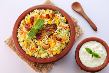 Chicken biryani Spicy Indian Malabar biryani Hyderabadi biryani, Dum Biriyani pulao golden bowl Kerala India Sri Lanka Pakistan basmati rice mixed rice dish with meat curry Ramadan Kareem, Eid