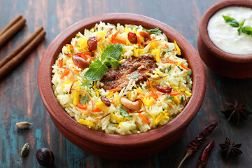 Chicken biryani Spicy Indian Malabar biryani Hyderabadi biryani, Dum Biriyani pulao golden bowl Kerala India Sri Lanka Pakistan basmati rice mixed rice dish with meat curry Ramadan Kareem, Eid