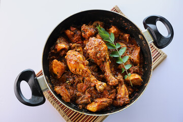 Masala Chicken curry with Appam Kerala breakfast , Hoppers pan cake , homemade chicken roast Indian spices , Asian cuisine spicy meat curry cooked in coconut milk . side dish Christian food Christmas