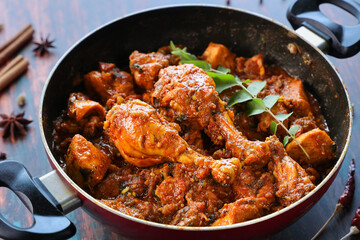 Masala Chicken curry with Appam Kerala breakfast , Hoppers pan cake , homemade chicken roast Indian spices , Asian cuisine spicy meat curry cooked in coconut milk . side dish Christian food Christmas