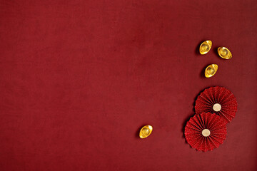 Chinese new year festival decorations made from chinese red paper fans and gold ingots.Copyspace