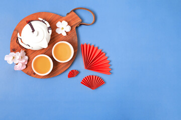 Chinese new year festival decoration with tea set, red paper fans, cherry blossom.Top view.