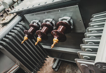 closeup shot of 3-phase distribution transformer Bushings with porcelain insulator