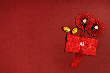 Chinese new year decorations with chinese good luck symbol, paper fans, gold ingots and envelope.