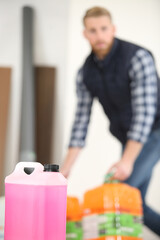 blurred image of man moving industrial plastic container