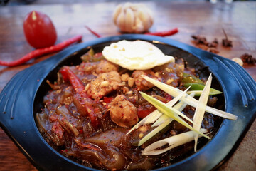 A spicy chicken on the black plate 