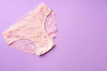 Women's panties on pink background with copy space