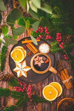 Mulled wine in white rustic mugs with spices and citrus fruit