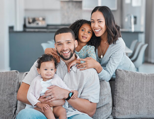 Happy family, portrait and home with mother, father and children together in the living room at home for love, care and happiness. Smile of a black man, woman and kids in their Puerto rico house