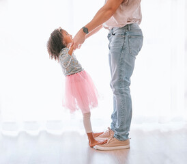 Father, child and dance in ballet tutu for fun, bonding and artistic expression with love and care in childhood. Dancer, dancing and man with daughter having fun in the family home being playful