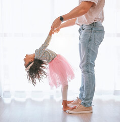 Happy, bonding and father teaching child to dance on feet with support holding hands in their...