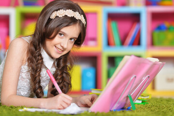 Portrait of cute little girl study at home 