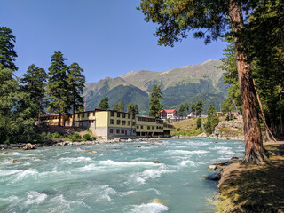 Arkhyz, Karachay-Cherkessia, Russia - August 26, 2022: View of the Zelenchuk River in the village of Arkhyz against the backdrop of the Caucasus Mountains